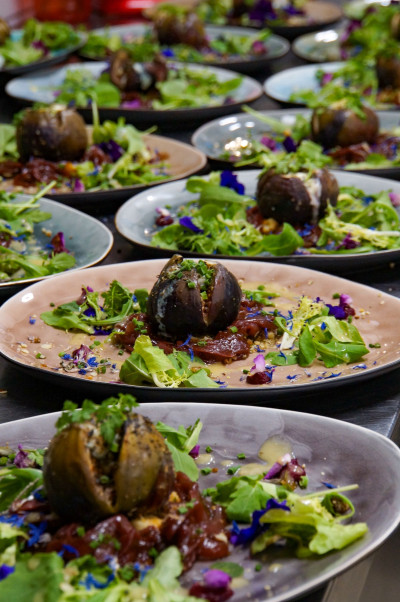 Several plated dishes prepared for a dinner catering event