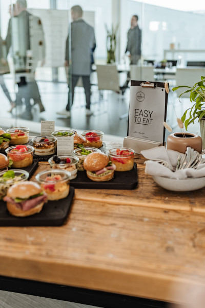 Buffet table with people attending a conference in the background