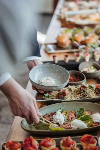 Guest assembling a plate at the buffet